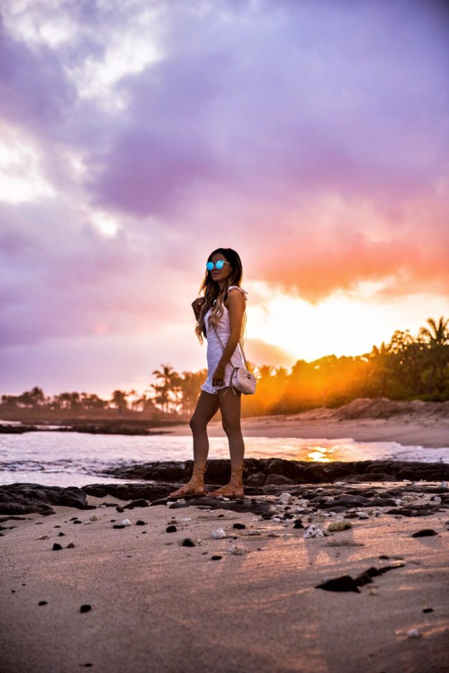 fashion blogger mia mia mine wearing a white eyelet romper from revolve at the four seasons resort hualalai at sunrise on the big island hawaii