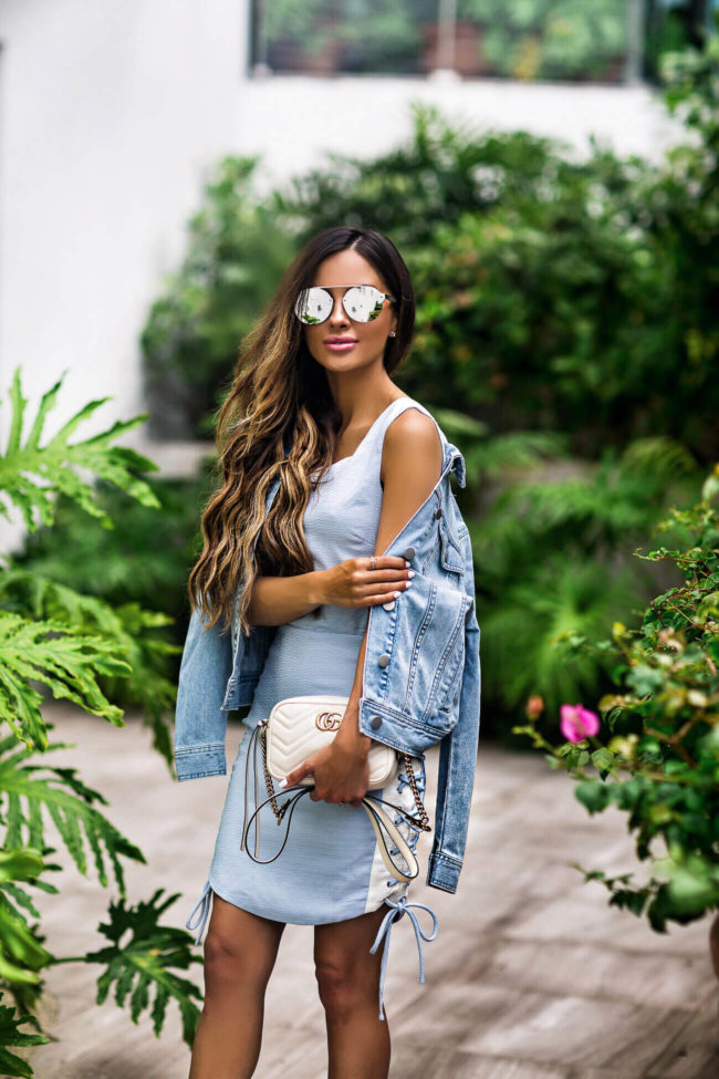 fashion blogger mia mia mine wearing quay mirrored sunglasses and a gucci marmont mini bag