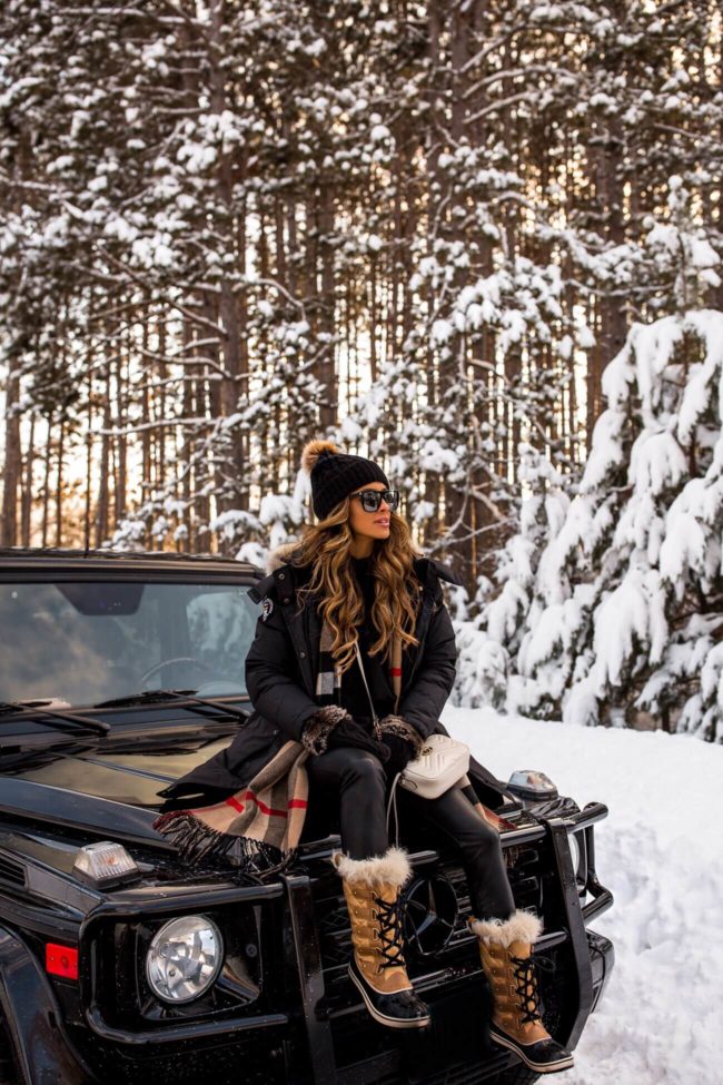 fashion blogger mia mia mine wearing a burberry scarf and sorel boots