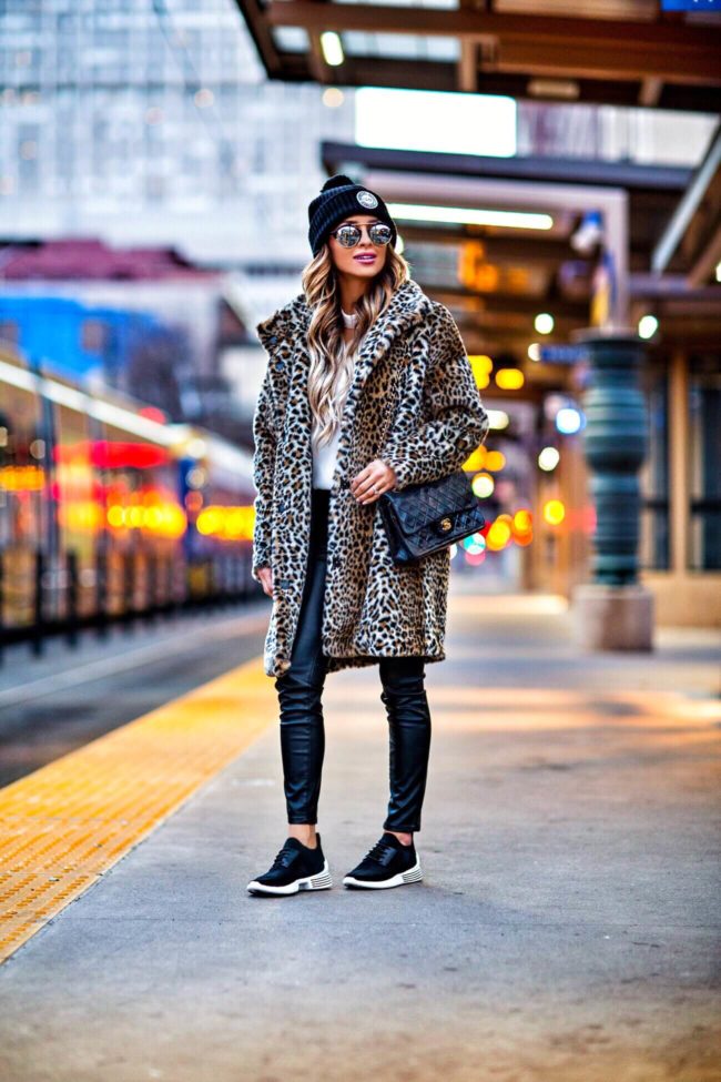 fashion blogger mia mia mine wearing kendall + kylie sneakers and a leopard coat