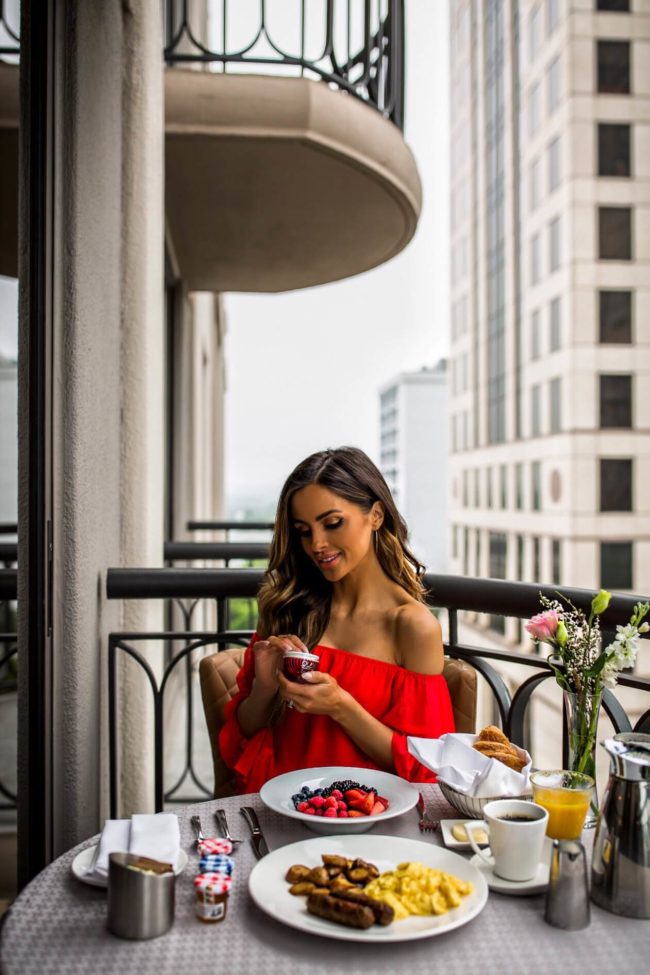 mia mia mine wearing a red romper and trying out the new olay regenerist whips