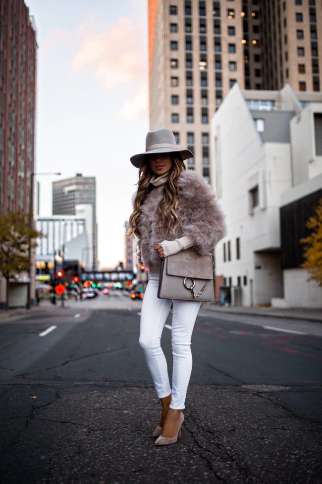 fashion blogger mia mia mine wearing a jocelyn feather bolero from shopbop and a janessa leone fedora with a chloe faye bag for winter 2018