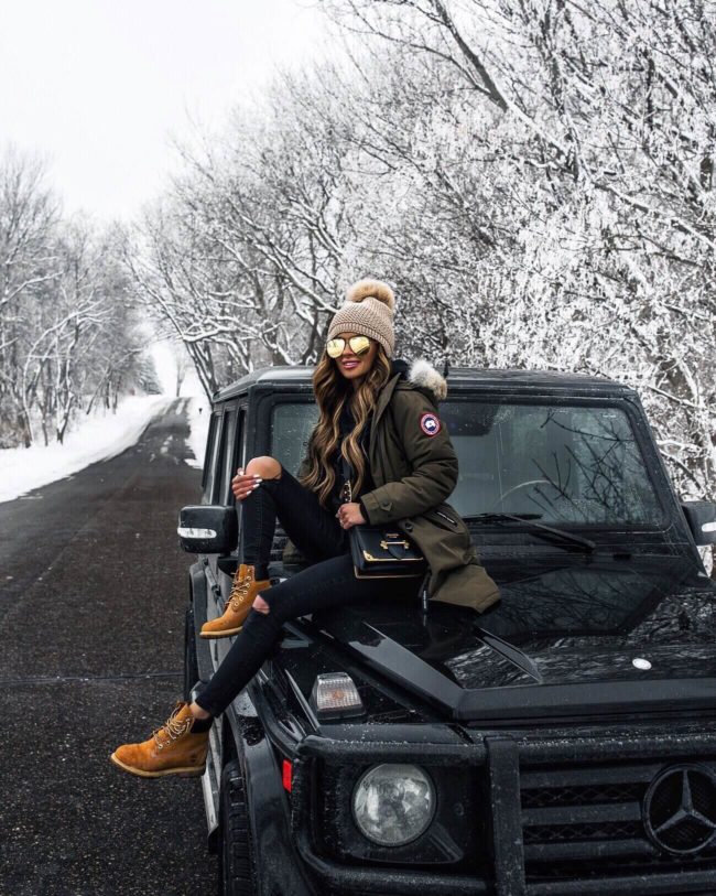 fashion blogger mia mia mine wearing a canada goose parka and timberland boots