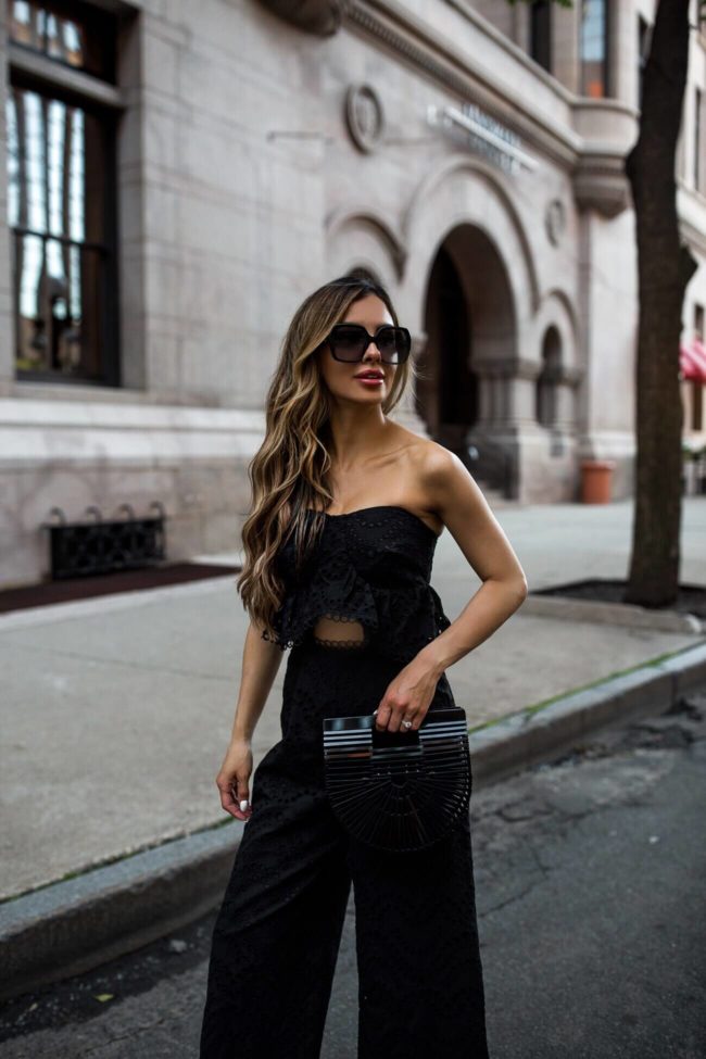 fashion blogger mia mia mine wearing an eyelet jumpsuit and gucci sunglasses