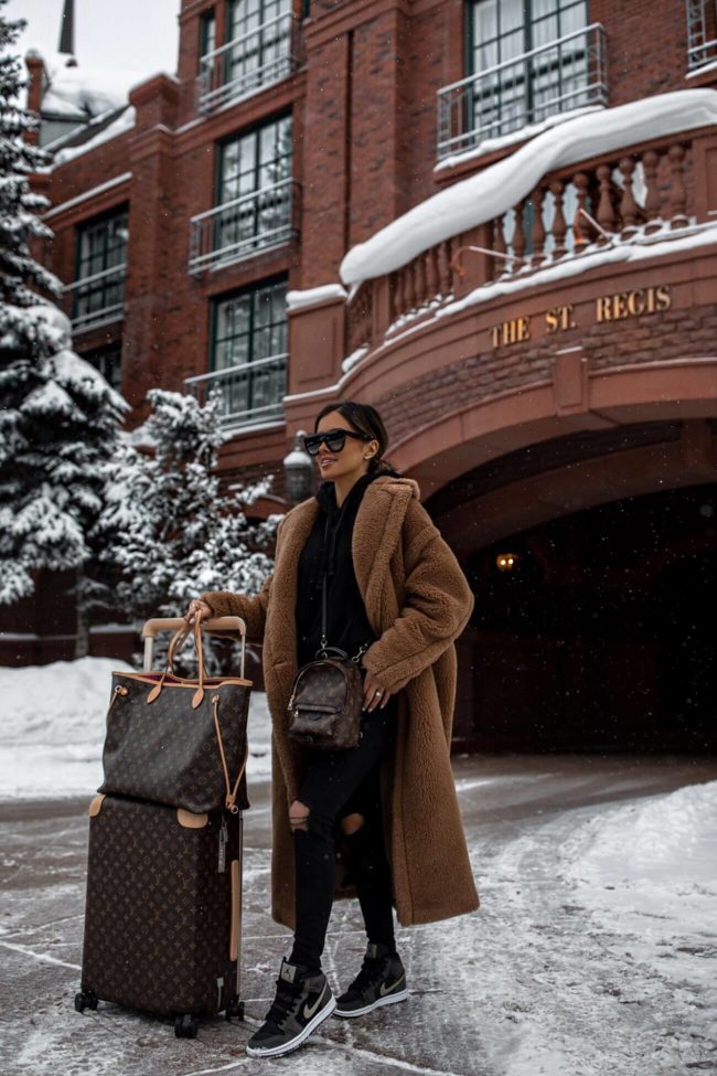 fashion blogger mia mia mine wearing a teddy bear coat and nike sneakers in aspen