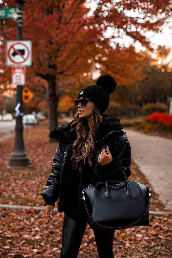 fashion blogger mia mia mine wearing a black puffer jacket from express