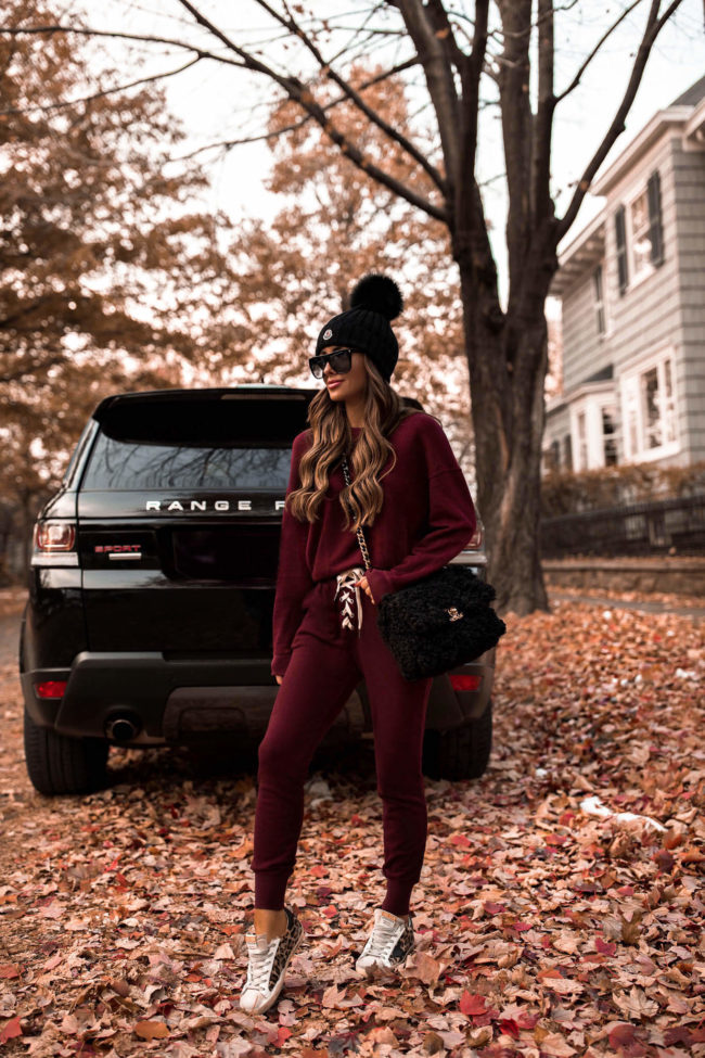 fashion blogger mia mia mine wearing a red sweatsuit from revolve