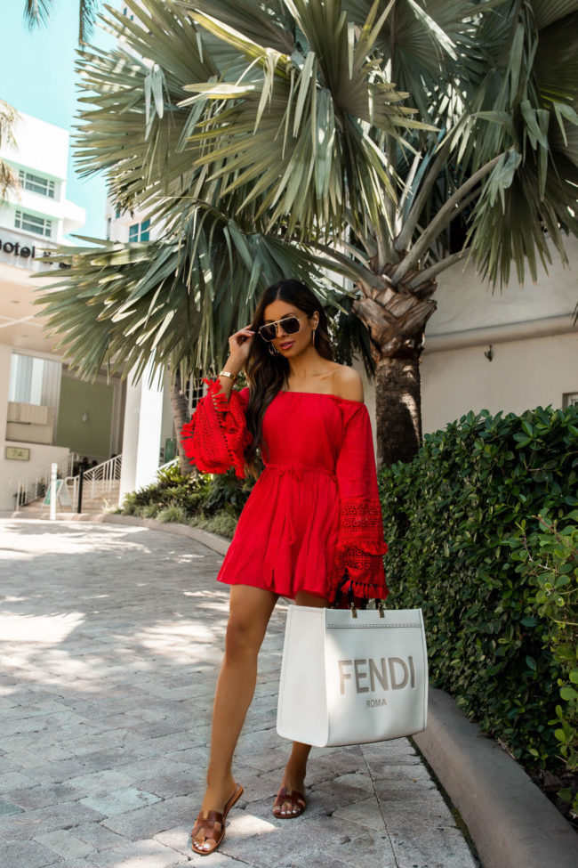 fashion blogger wearing a red dress by judith march in miami