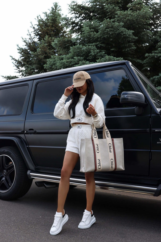 fashion blogger mia mia mine wearing an alo yoga quilted set and alexander mcqueen white sneakers