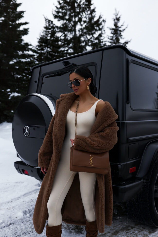 fashion blogger mia mia mine wearing a catsuit and sherpa coat