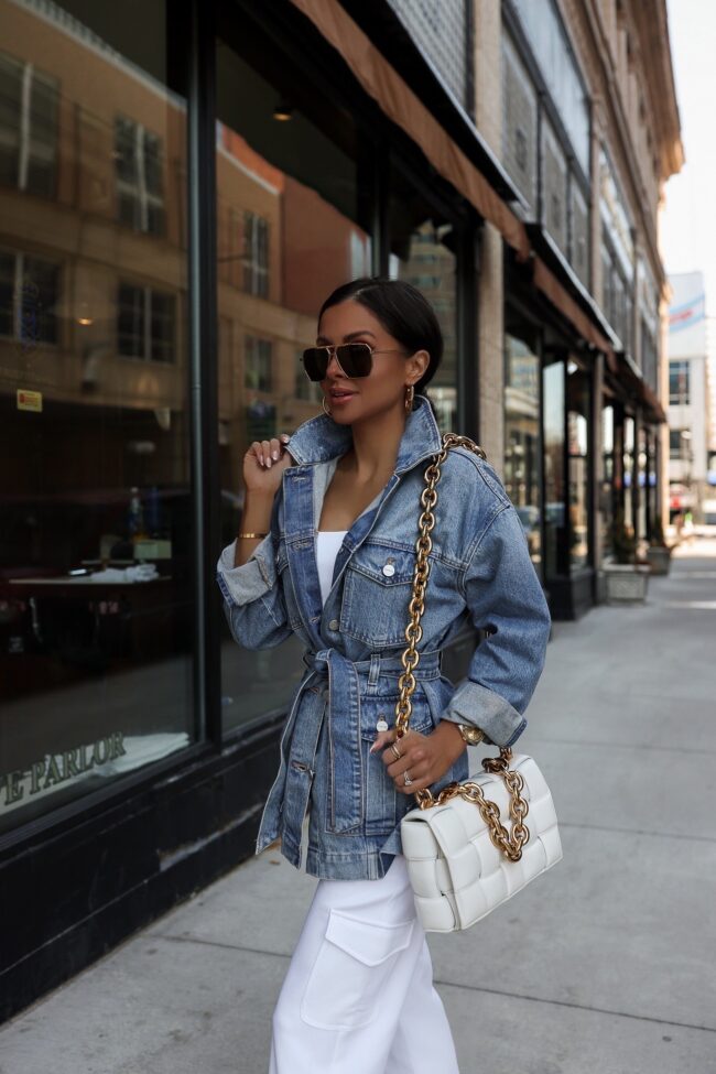 fashion blogger mia mia mine wearing a denim jacket from express