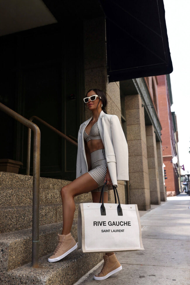 fashion blogger mia mia mine wearing nike high top tan sneakers and an alo yoga set