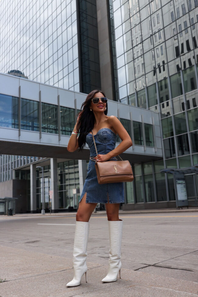 fashion blogger wearing a denim dress for the taylor swift eras tour