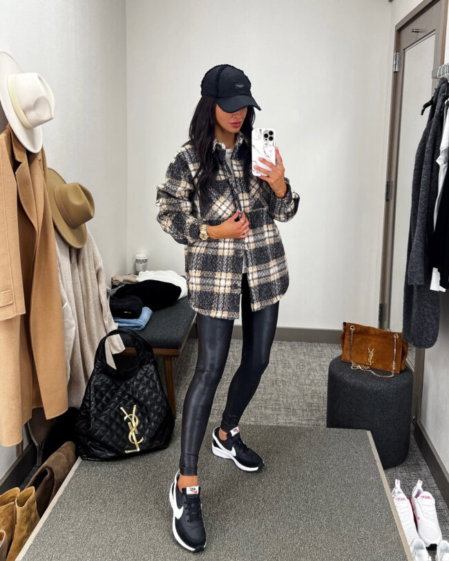 fashion blogger mia mia mine wearing a plaid shacket and faux leather leggings