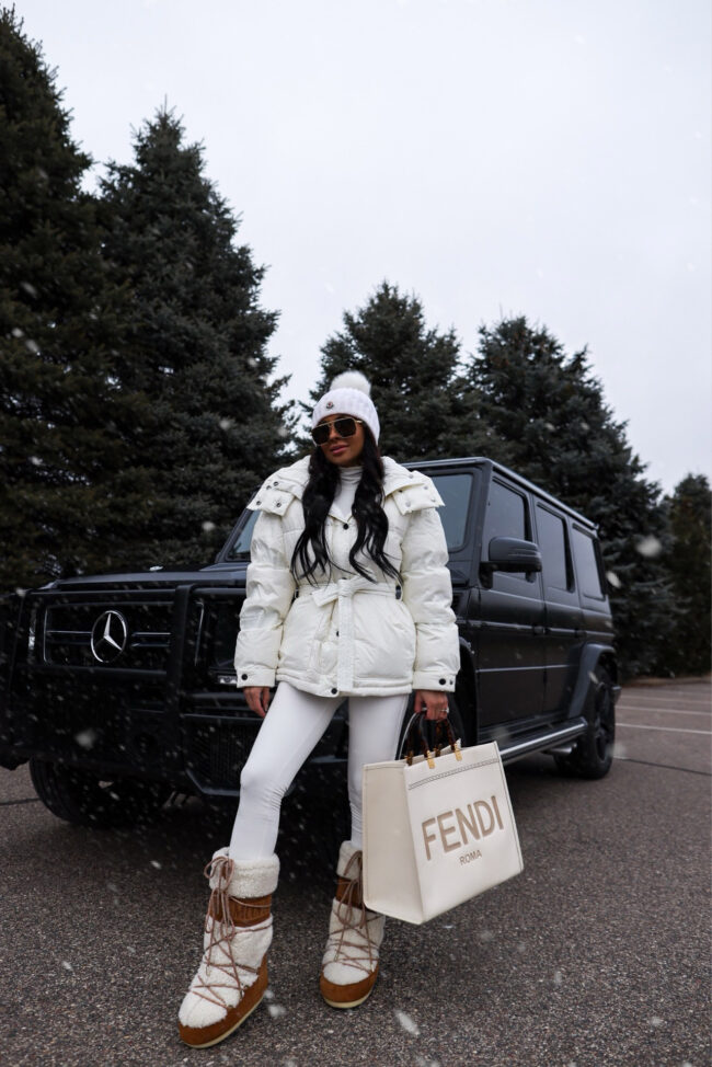 fashion blogger wearing an all white ski outfit