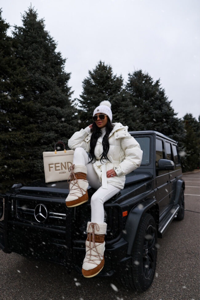 fashion blogger mia mia mine wearing a white ski outfit from amazon